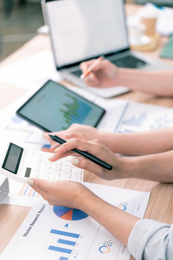 Business people consulting meeting working brainstorming new business project using calculator laptop desk office.jpg